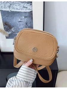 Minimalist double zipper crossbody bag for women in light brown faux leather with ring logo