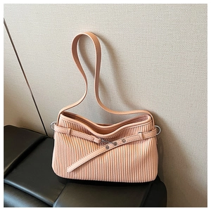 Detail of peach pink pleated tote bag with silver eyelet strap and metallic ring