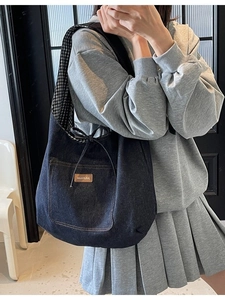 Denim tote bag with drawstring detail and vichy plaid lining for casual daily use