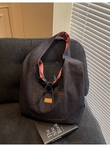 Deep blue denim hobo tote bag with striped lining and orange leather patch detail
