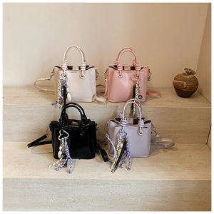 Chic bucket bags set featuring knot handles and decorative charms in four soft colors