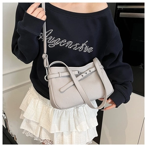 Grey pleated crossbody bag with silver hardware shown on a model for daily wear