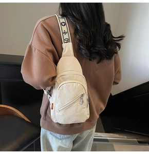Detail of white nylon chest bag with decorative jacquard strap on casual model