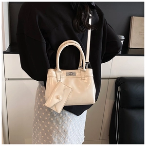 Detail of cream white PU leather bucket bag with silver twist lock and mini pouch