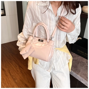 Pink patent leather bucket bag with silver twist lock and mini triangle pouch detail