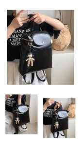 Close-up of black glossy faux leather backpack with retro texture and cute charm