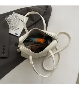 Top view of cream white Boston bag showing spacious interior and lychee leather texture