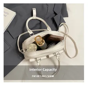 Internal view of a minimalist white Boston bag showing capacity for phone and perfume