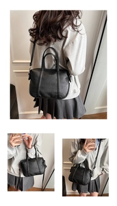 Detail of black lychee texture PU leather bag showing adjustable strap and double handles