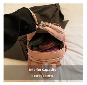 Macro view of pink mini backpack interior storage capacity and lychee grain texture