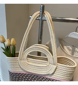 Close-up of woven straw tote bag with color-block design and dual handle shoulder straps