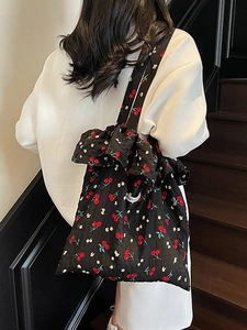 Retro black canvas shoulder bag featuring red cherry prints and ruffled edges