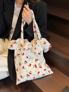 Minimalist white canvas tote bag with red cherry print and sweet ruffle trim detail
