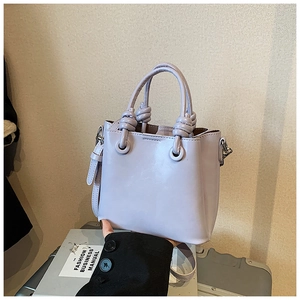 Detailed view of lavender bucket bag with unique knot handle and silver metal hardware