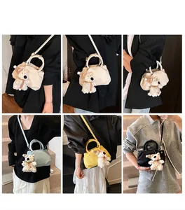 Detail view of ruched bucket bags in beige, blue, yellow and black with dog charms