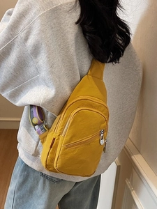 Yellow nylon crossbody chest bag with colorful patterned strap and multi-pocket design