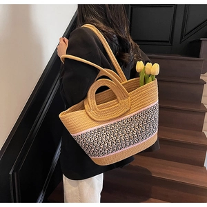 Detail of hand-woven tote bag with colorful geometric patterns and double handles