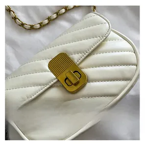Détail du sac en similicuir matelassé en V blanc avec fermoir doré et bandoulière chaîne