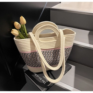 Detail of hand-woven tote bag with tri-color rope texture and geometric pattern