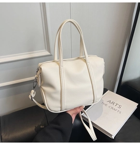 Detail of white lychee pattern PU leather handbag with detachable shoulder strap and hardware
