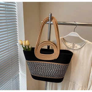 Detail of a large woven tote bag with tricolor patchwork, round handle and shoulder strap