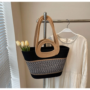 Detail of hand-woven tote bag with rope handles and contrast stitching pattern