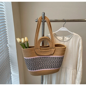 Close-up of woven tote bag with geometric pattern straps and decorative yellow tulips