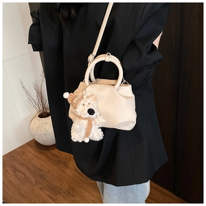 Crossbody cream bucket bag with litchi grain texture and a cute plush bear charm