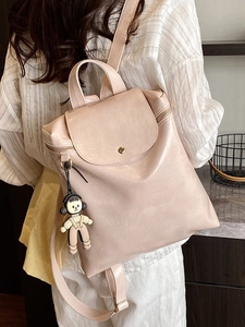 Minimalist light pink PU leather backpack with adjustable straps and cute plush charm