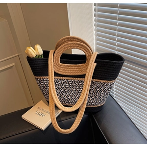 Close-up of woven tote bag with dual straps showing detailed texture and color block design
