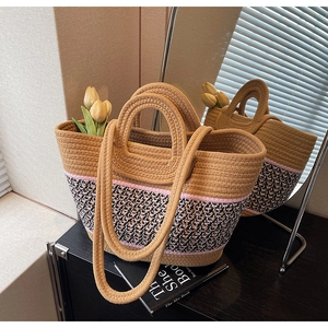 Close-up of woven tote bag with multi-color pattern and double handles in a cozy setting