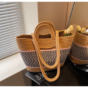 Detail of woven tote bag with geometric patterns and dual handles for beach vacation