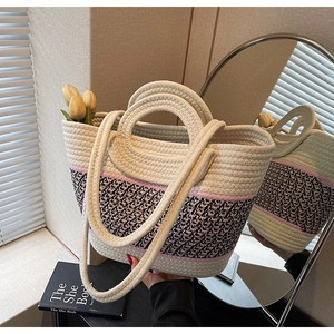 Detail of hand-woven tote bag with ethnic pattern, short handles and shoulder straps