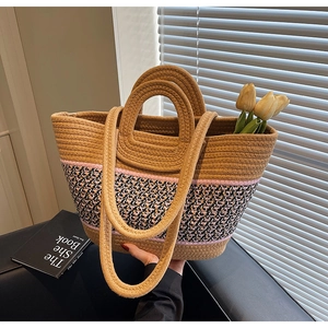 Detail of hand-woven tote bag with dual straps and colorful geometric patterns