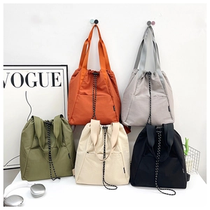 Detailed display of multi-color drawstring nylon backpacks in orange, grey and olive