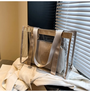 Detail of transparent PVC beach tote with gold trim and removable inner pouch