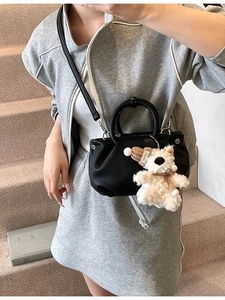 Chic black lychee pattern bucket bag with a cute bear pendant and pleated style
