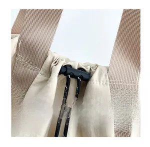 Detail of multi-functional bucket bag showing braided drawstring and sturdy woven handle