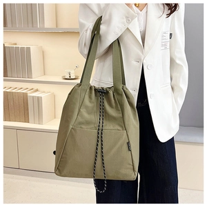 Detail of army green nylon drawstring bucket bag with durable wide straps and toggle closure