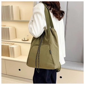 Detailed side view of olive green drawstring nylon backpack with large capacity