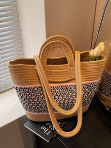 Large woven tote bag with geometric patterns and dual handles for beach or daily use