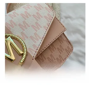 Détail de sac à main en cuir texturé avec logo M doré et coutures de précision