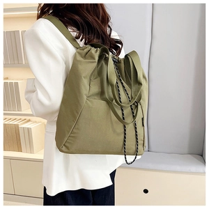 Olive green versatile drawstring backpack showing model back view and spacious textile texture