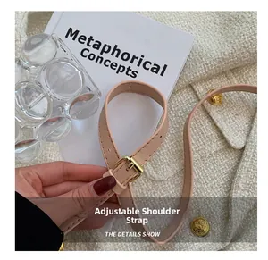 Détail de la bandoulière réglable en cuir rose clair avec boucle en métal doré chic