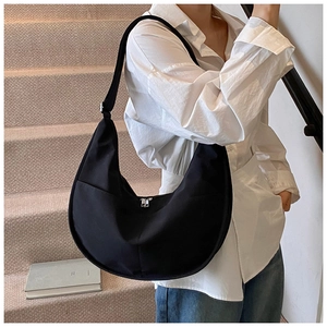 Detailed view of the black crescent hobo bag with adjustable strap and silver zipper