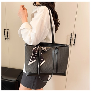 Vue détaillée d'un grand sac cabas avec anses en cuir et foulard à motif de cœur