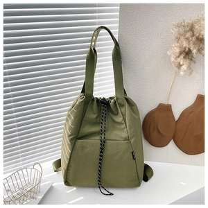 Detail view of military green drawstring backpack with side stripes and brand tag