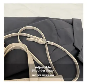 Close-up of adjustable strap on beige litchi leather bag with silver metal buckle