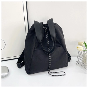 Detail of high-density nylon backpack featuring braided drawstring and reinforced strap