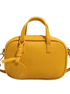 Yellow pebble leather crossbody bag with a smiley charm and adjustable shoulder strap